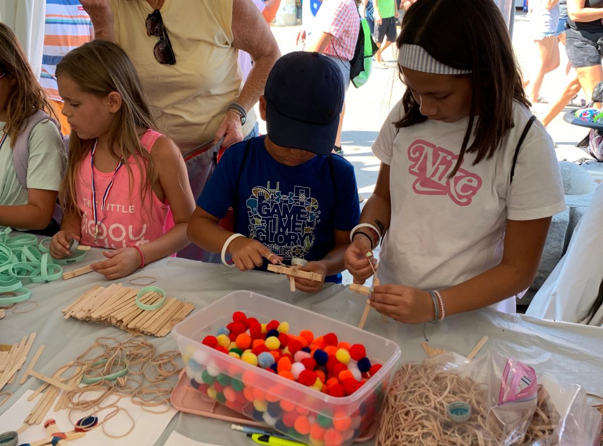 Children participate in a hands-on STEM activity at the State Fair.