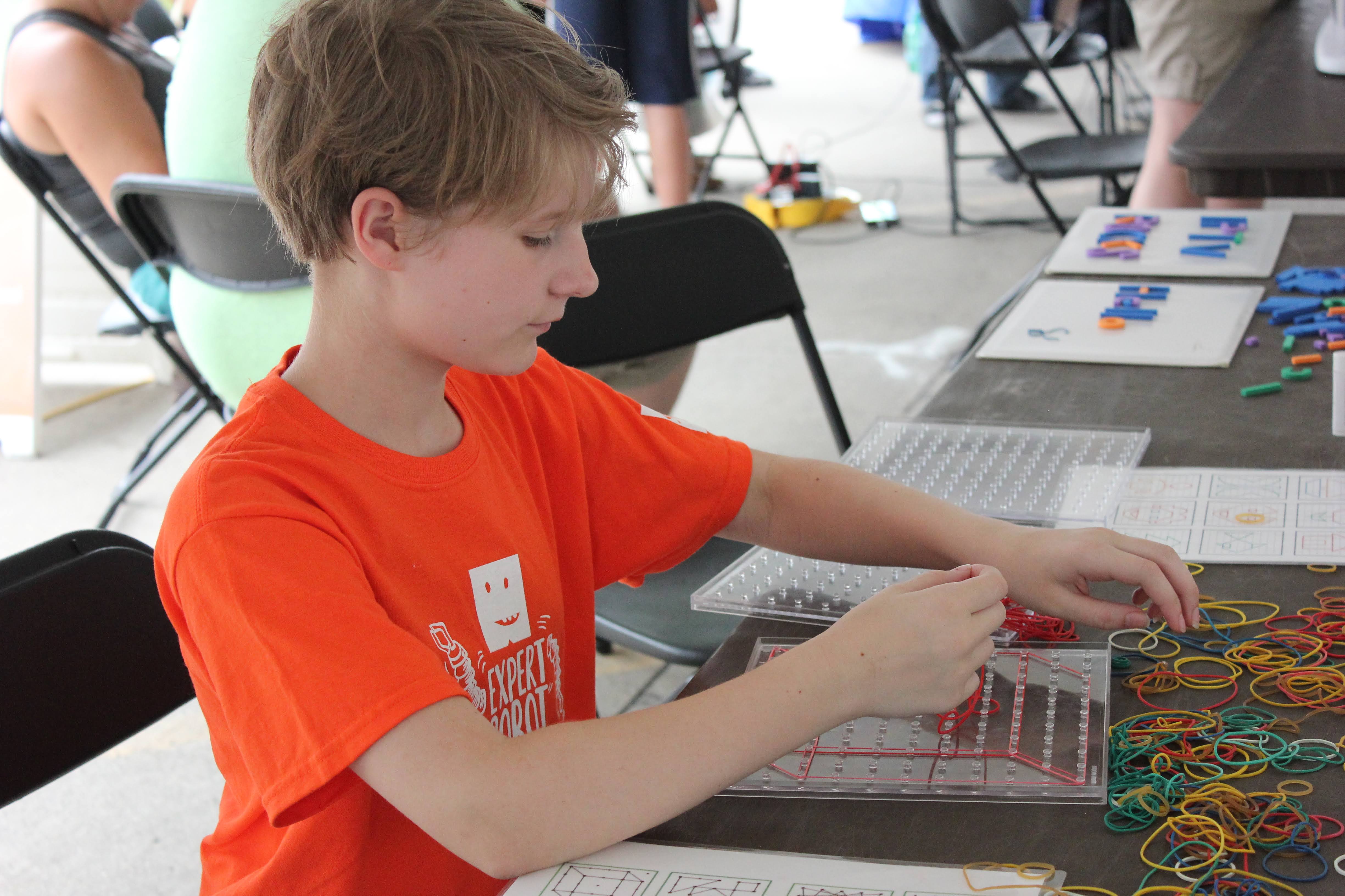Youth participates in hands-on activity at STEM Day at the Fair